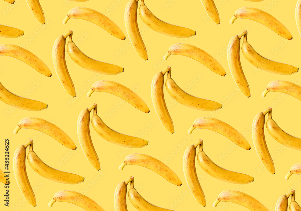 Fototapeta premium Ripe bananas on a yellow background. Bananas pattern.