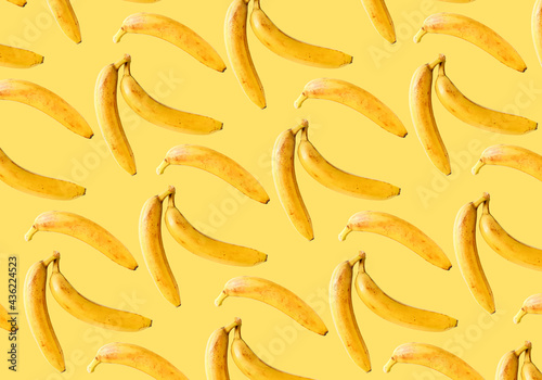 Ripe bananas on a yellow background. Bananas pattern.