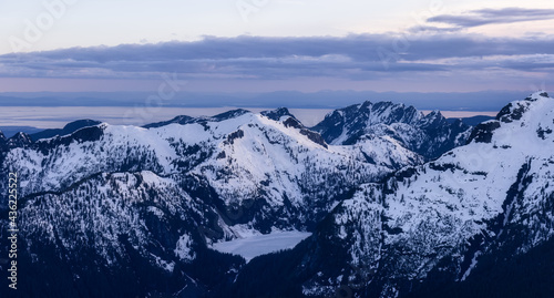 Aerial View from Airplane of Canadian Mountain Landscape in Spring time. Colorful Sunset Sky. North of Vancouver  British Columbia  Canada. Authentic Image