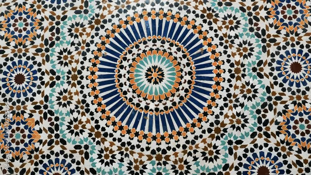 Colorful zellige pattern in traditional Islamic geometric design from a public fountain in Marrakech, Morocco. Made with natural colors from indigo, saffron, mint, kohl. Camera movement zooming in.