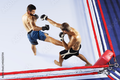 Two professional fighters punching or boxing isolated in the fight ring. High angle view. Collage