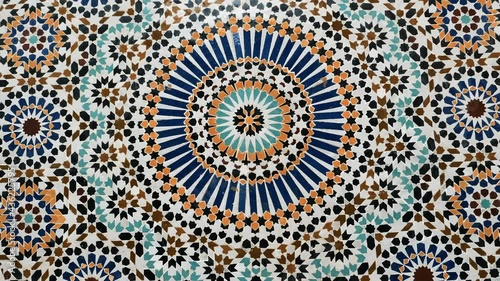 Colorful zellige pattern in traditional Islamic geometric design from a public fountain in Marrakech, Morocco. Made with natural colors from indigo, saffron, mint, kohl. Camera movement zooming in.