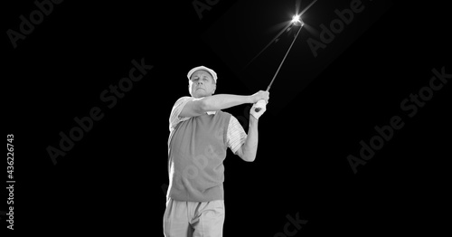 Composition of caucasian male golf player with golf club and copy space in black and white