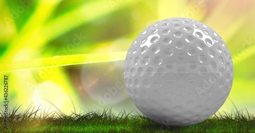 Composition of golf ball in grass, green background and copy space