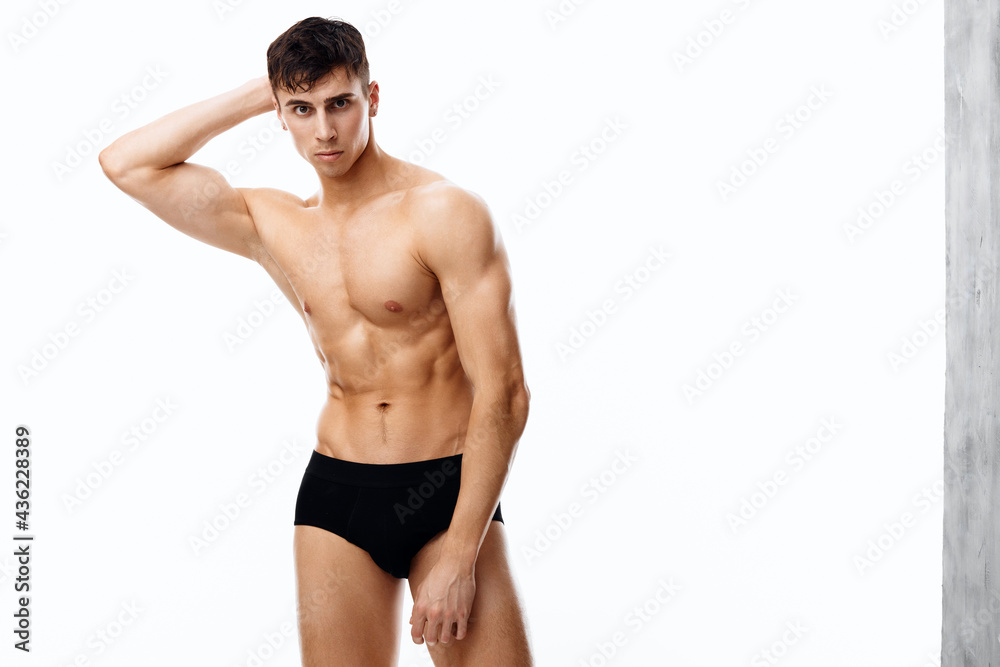 sexy athlete guy in black panties holds hand behind head and cropped view naked torso sexy athlete guy in black panties holds hand behind head and cropped view naked torso
