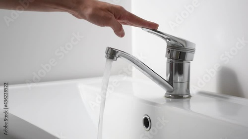 Saving water concept. Woman turns off water. 