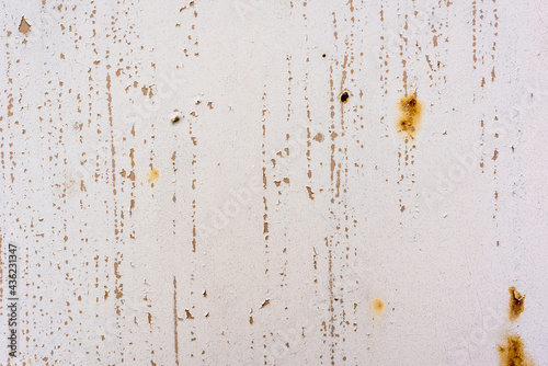 Background of rusty metal wall covered with paint peeling off