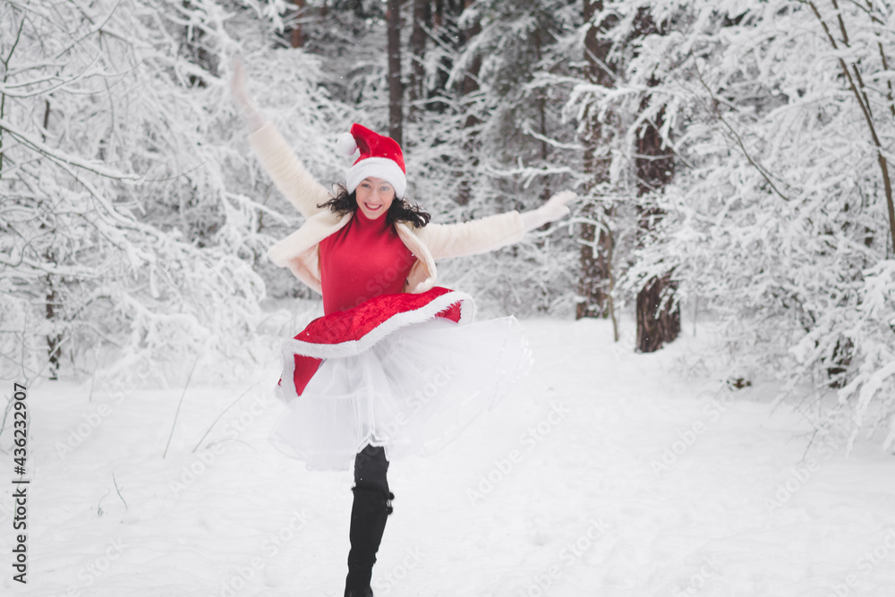 Beautiful girl in winter snowy forest in christmas clothes