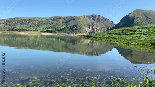 Rosamarina lake in Caccamo near Palermo. It is among the largest lakes in Sicily. Sport fishing and water sports in Sicily. Lake surrounded by rich vegetation. photo