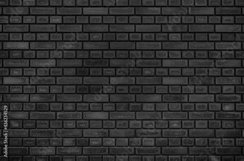 Empty texture background of black brick wall. Home, office, cafe, restaurant design backdrop. 