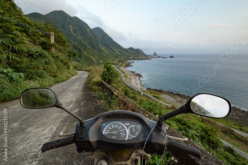 View of the island of Lanyu rugged coast over motorcycle handlebars. Taiwan's offshore islands travelling. photo