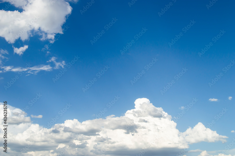 Sun rays coming out of the scattered clouds in the blue sky Sun rays coming out of the scattered clouds in the blue sky