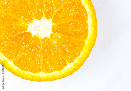 Close up photo of Orange Fruit on the white and orange background. Citrus cut in half  inside  macro view. Minimalism  original and creative image. Beautiful natural wallpaper.