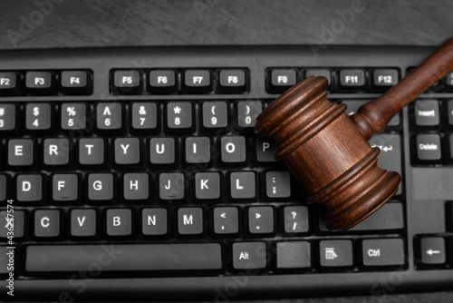 Gavel on computer keyboard. Internet auction concept. Legal certainty on the Internet. photo