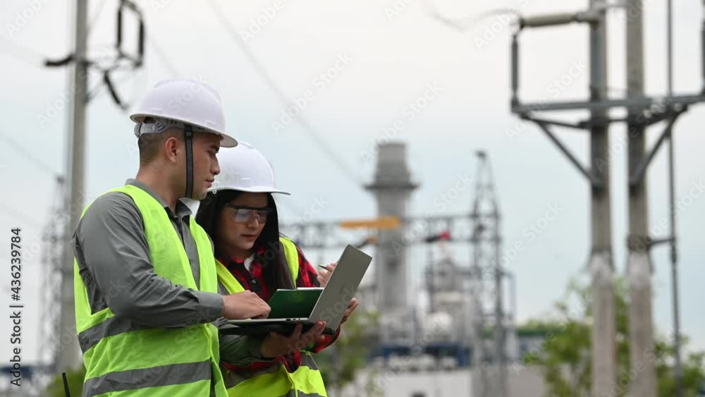 Two engineer working at power plant,Work together happily,Help each other analyze the problem,Consult about development guidelines Two engineer working at power plant,Work together happily,Help each other analyze the problem,Consult about development guidelines