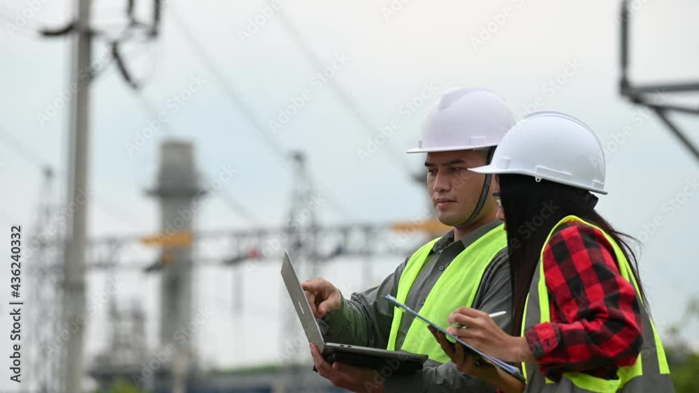 Two engineer working at power plant,Work together happily,Help each other analyze the problem,Consult about development guidelines Two engineer working at power plant,Work together happily,Help each other analyze the problem,Consult about development guidelines