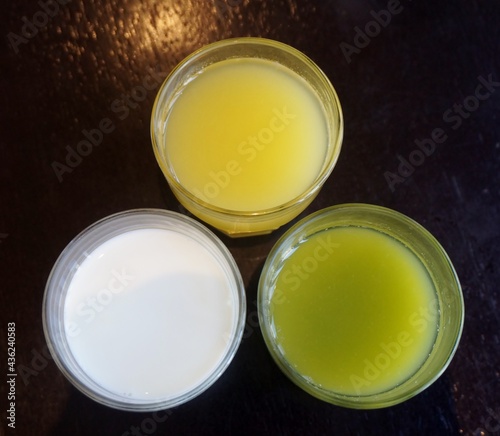 Assortment of healthy fresh juices on wooden table background