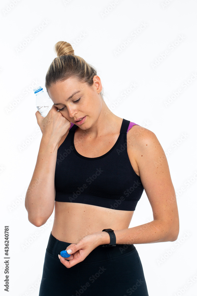 Young woman in sports wear after workouts drinking water Young woman in sports wear after workouts drinking water