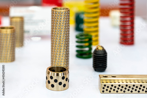 various type alloy copper or brass oilless or oil free bush with embedded solid lubricant equipment of mold or metal stamping die system for industrial on table with other instrument