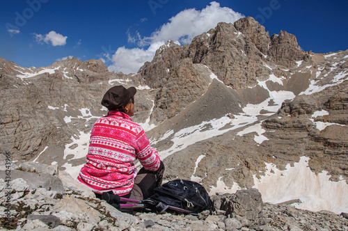 A girl sits on a pass high in the Aladaglara mountains in Turkey and admires the clouds