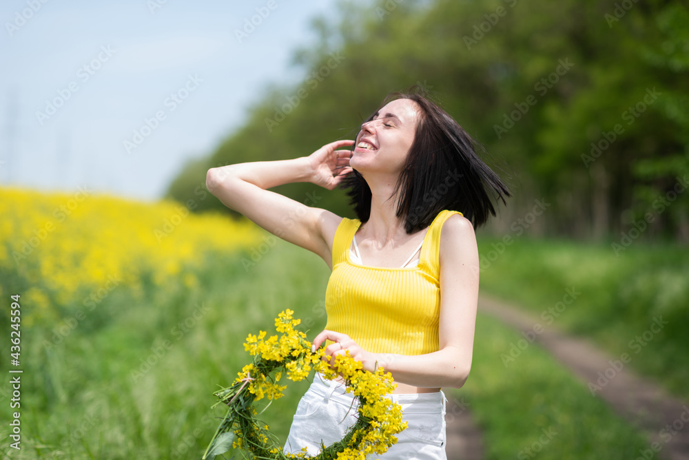 Portrait of a young beautiful girl in front of a yellow rapeseed field Portrait of a young beautiful girl in front of a yellow rapeseed field