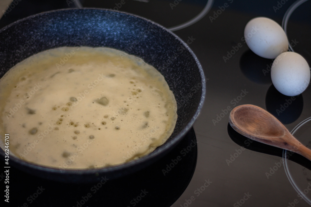 Homemade pancakes made from flour and egg. Kitchen at home with induction appliance. Modern cuisine Homemade pancakes made from flour and egg. Kitchen at home with induction appliance. Modern cuisine