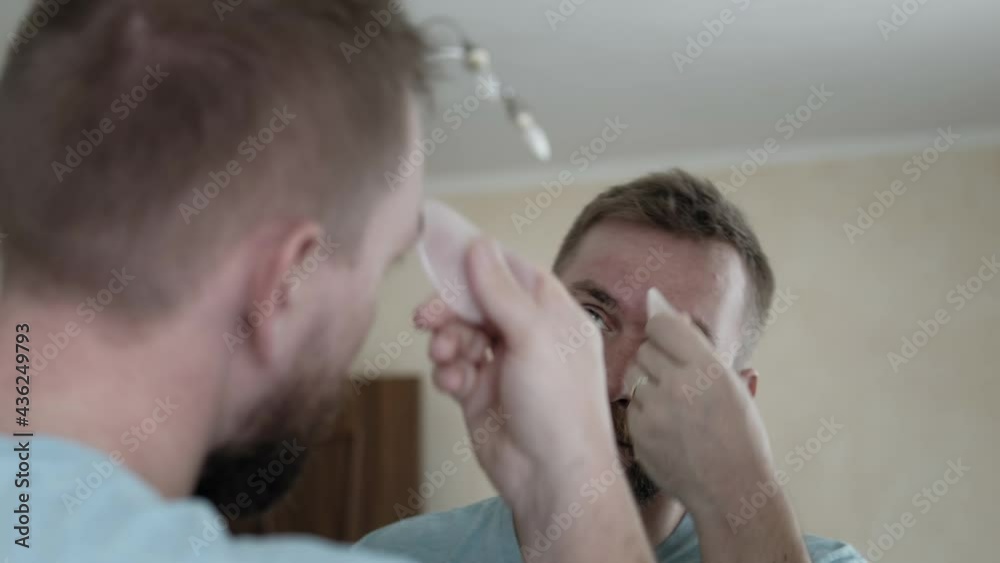 Man takes care of his face at home Man takes care of his face at home
