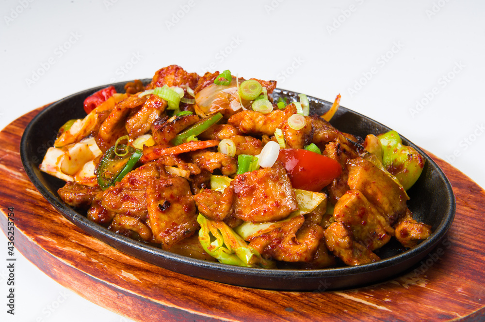Asian beef and vegetables in a spicy sauce at a Korean restaurant. White background......... Asian beef and vegetables in a spicy sauce at a Korean restaurant. White background.........