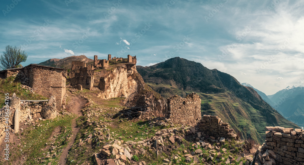 Summer view of ruins and towers of the aul ghost Goor in Dagestan in the evening light. Russia.