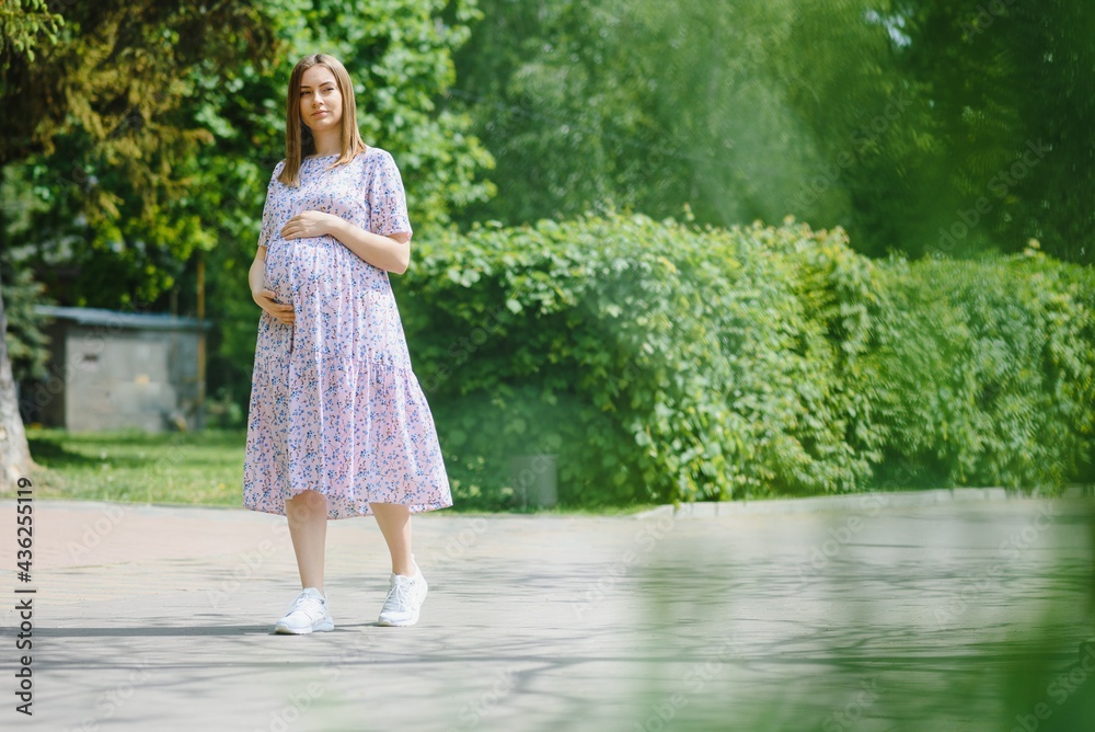 The pregnant girl on walk in city park The pregnant girl on walk in city park
