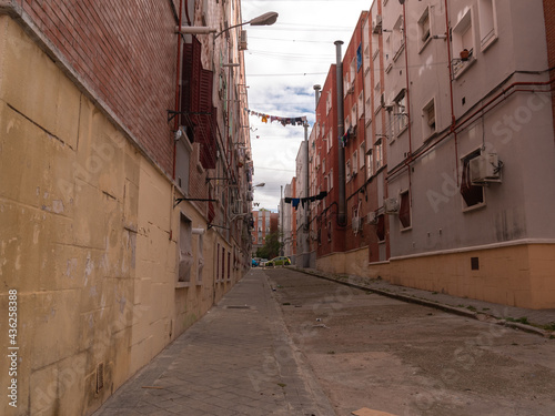 POOR NEIGHBORHOOD STREET WITH CLOTHES AND GARBAGE photo