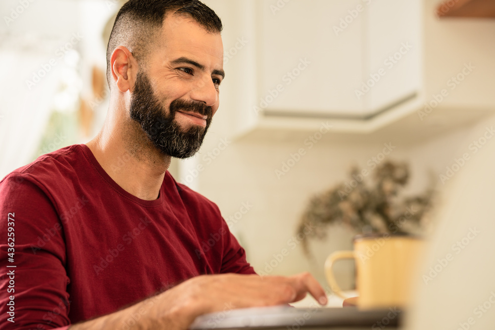 man with finger amputation smiling and looking at laptop screen.. man with finger amputation smiling and looking at laptop screen..