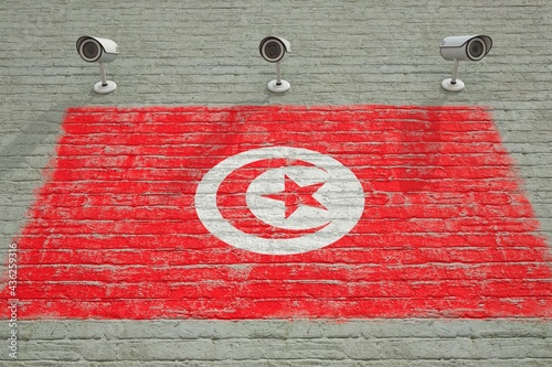 Brick wall with printed national flag of Tunisia and CCTV cameras. Surveillance system conceptual 3D rendering