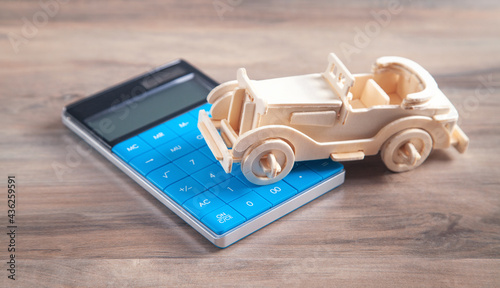 Wallpaper Mural Wooden toy car and calculator on the wooden background. Torontodigital.ca