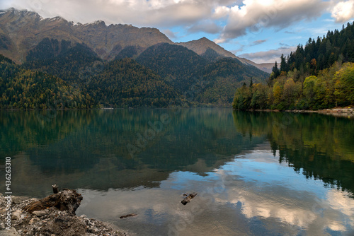 Mountain lake Ritsa and the reflection of clouds in the water