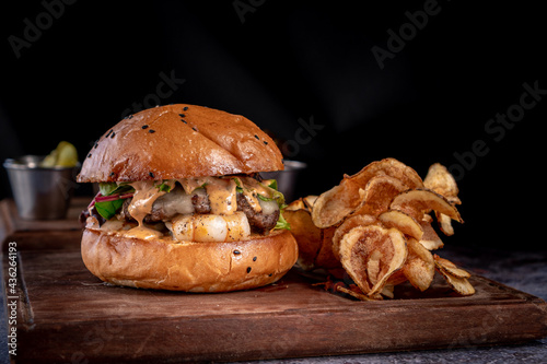 Tasty shrimp and beef burger with french fries