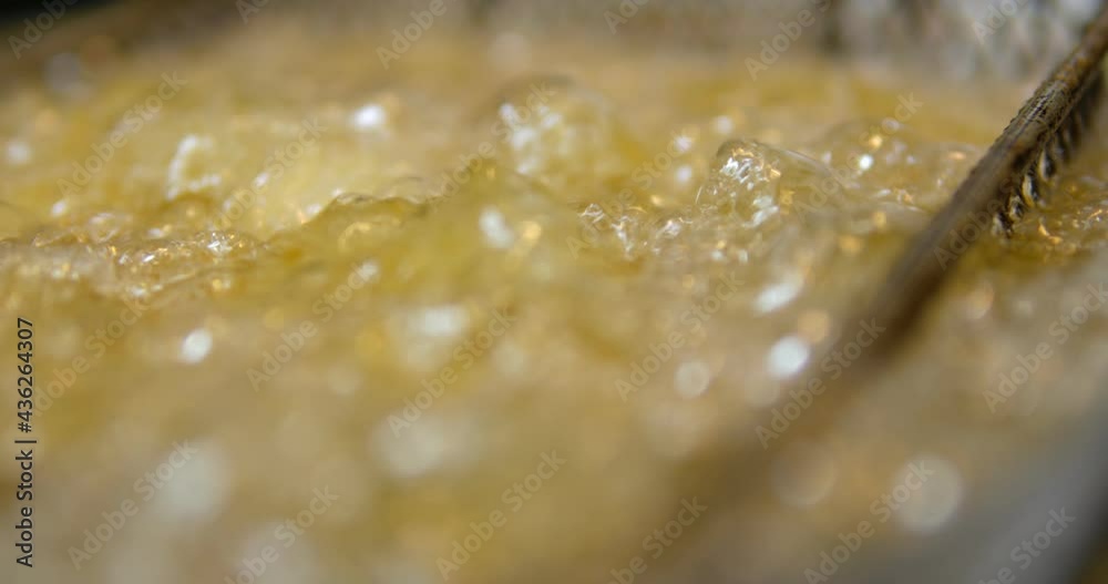 Cooking oil boiling and bubbling in fryer for deep frying dishes in a