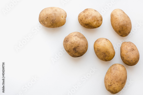 Obraz na płótnie young potatoes on a white plate, potatoes on a white plate