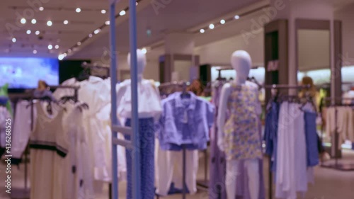 Wallpaper Mural At the entrance to a women's clothing store, there are manikines in a new collection of clothing. An anti-theft frame is installed at the entrance. Shopping in malls Unrecognizable place in blur. Torontodigital.ca