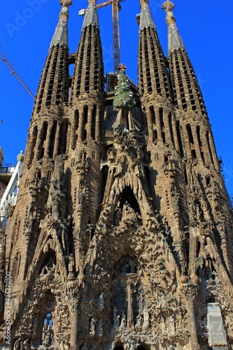 The towers of the famous Sagrada Familia cathedral in Barcelona in Spain with construction work in the background