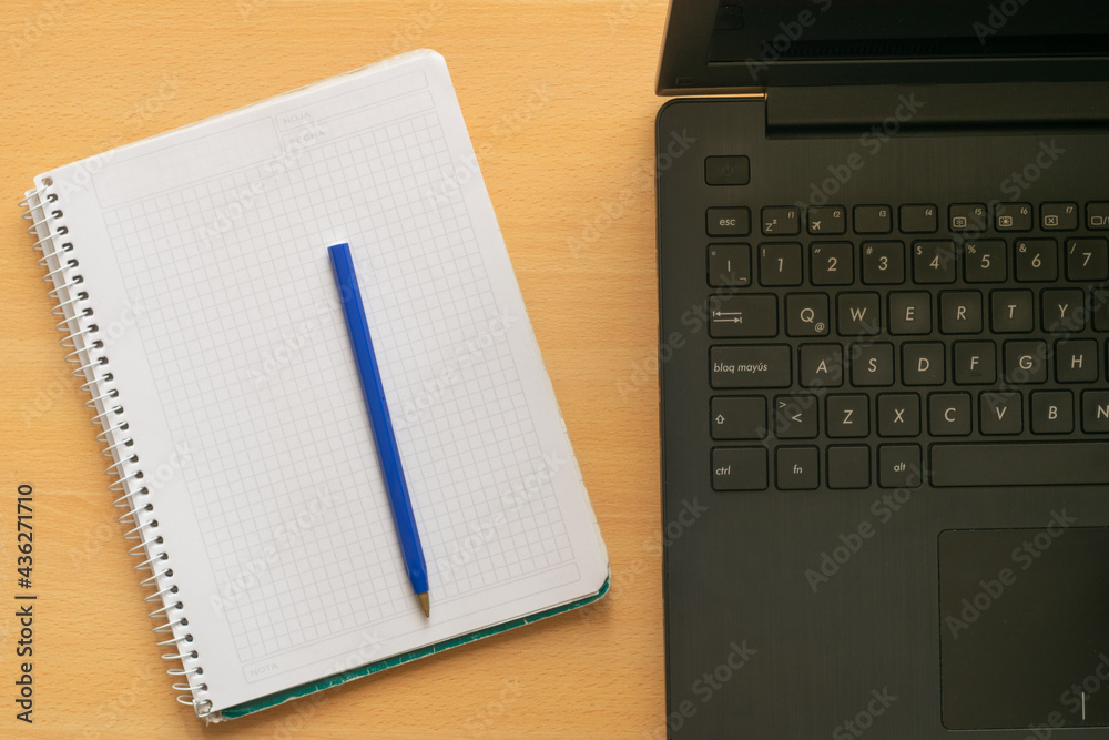 Laptop , blank notebook and cheap ballpoint pen Laptop , blank notebook and cheap ballpoint pen