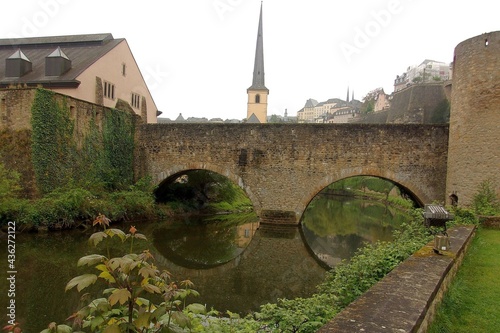 The old stone bridge on the river Alzette, the Grund disctrict in Luxembourg City, Luxembourg photo