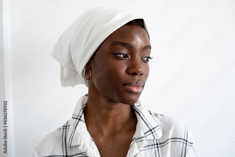 Portrait of a young woman wearing a white headscarf Portrait of a young woman wearing a white headscarf