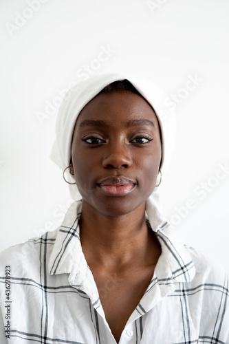 Portrait of a young woman wearing a white headscarf