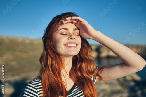 happy woman on the beach in the mountains near the river high cliffs landscape fresh air