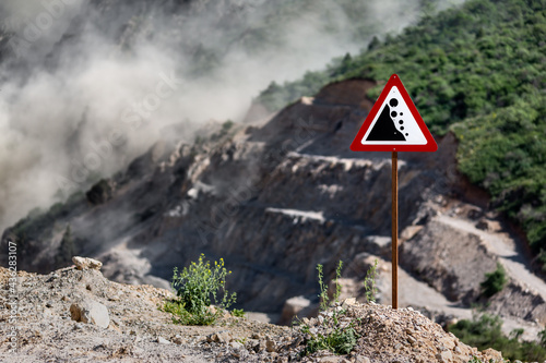 Road sign rockfall. Building a road in the mountains