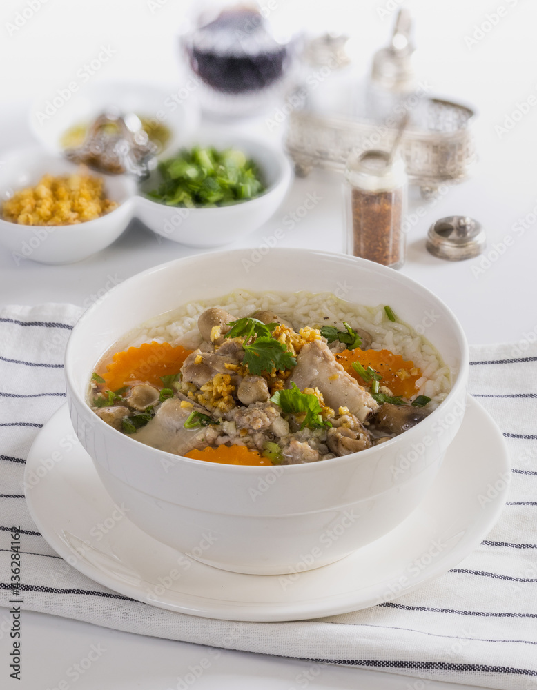 Pork boiled rice a white bowl on a table for breakfast.