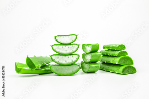 Aloe vera, Close-up slices of green fresh aloe vera plant stacked and aloe vera stalk or leaves with water dropping isolate on white background.