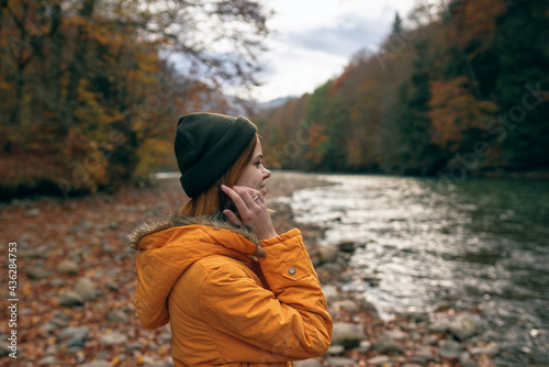 woman outdoors autumn forest mountains river travel