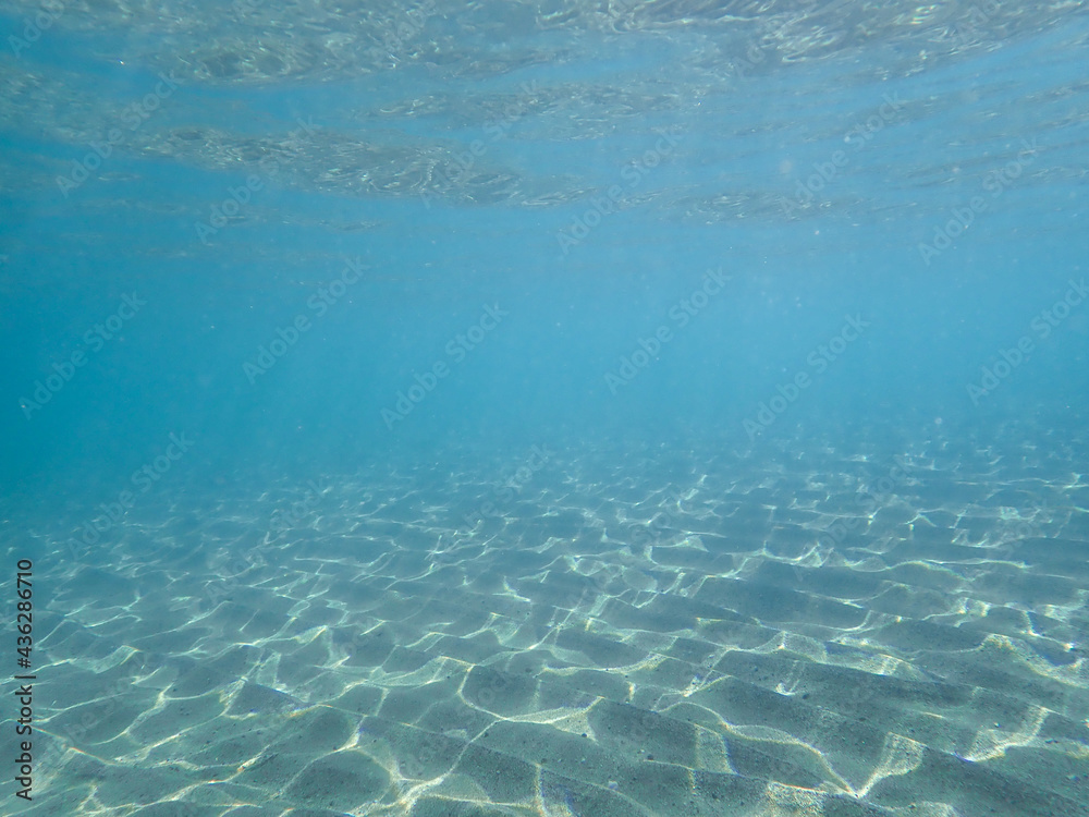 Tropical blue ocean with white sand underwater in Hawaii, underwater blue ocean wide background with sandy sea bottom, Real natural underwater view of the Mediterranean Sea, , Ocean background
